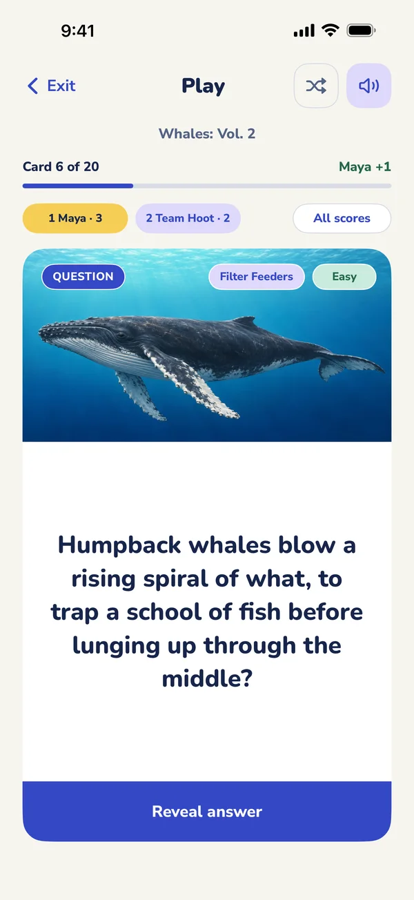 A question card in the app, under a picture of a humpback whale, with Reveal answer below.